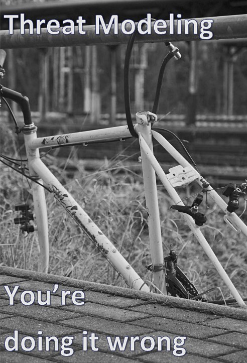 A bicycle frame locked to a fence, wheels and other parts stolen